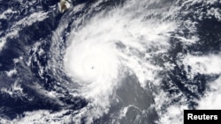 Hurricane Lane, upgraded to a Category 5 storm, is pictured approaching Hawaii, U.S. in this Aug. 21, 2018 NASA handout satellite photo.