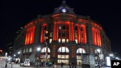 FILE - South Station is illuminated red to raise awareness for the bleeding disorders community on World Hemophilia Day, April 17, 2016, in Boston. A new gene therapy is offering hope for a cure for hemophilia.