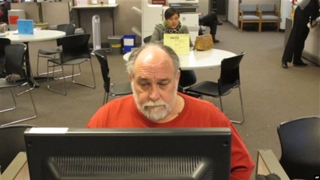 FILE - Richard Mattos, 59, looks for jobs at state-run employment center in Salem, Oregon.