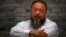 Chinese dissident artist Ai Weiwei sits on a chair in the courtyard of his studio, in Beijing, June 20, 2012.