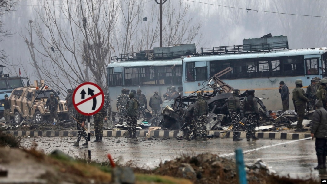 Indian paramilitary soldiers stand by the wreckage of a bus after an explosion in Pampore, Indian-controlled Kashmir, Feb. 14, 2019. 