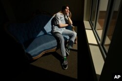 Grayson Hart sits for a portrait at the Ned R. McWherter West Tennessee Cultural Arts Center in Jackson, Tenn., on Saturday, March 4, 2023, where he directs a youth theater program. (AP Photo/Mark Zaleski)