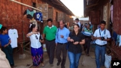 In this Feb.15, 2013 photo, U.N. human rights envoy for Myanmar Tomas Ojea Quintana, center, visits a refugee camp in Myitkyina, north Kachin state, Myanmar. The UN's human rights envoy to Myanmar Tomas Ojea Quintana concluded his six-day mission to Myan