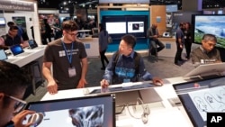 Workers demonstrate Microsoft devices at the Microsoft Build 2017 developers conference in Seattle, May 10, 2017. 