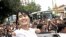 Burma's pro-democracy leader Aung San Suu Kyi greets supporters as she leaves her National League for Democracy party following her meeting with newly elected lawmakers at the party headquarters in Rangoon, April. 7, 2012.