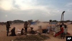 FILE - In this photo taken on January 23, 2020, gold panners break stones in Kidal, Mali. 