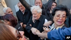 FILE - Fikret Abdic, center, greets his family members upon his release from prison in Pula, Croatia, March 9, 2012. 