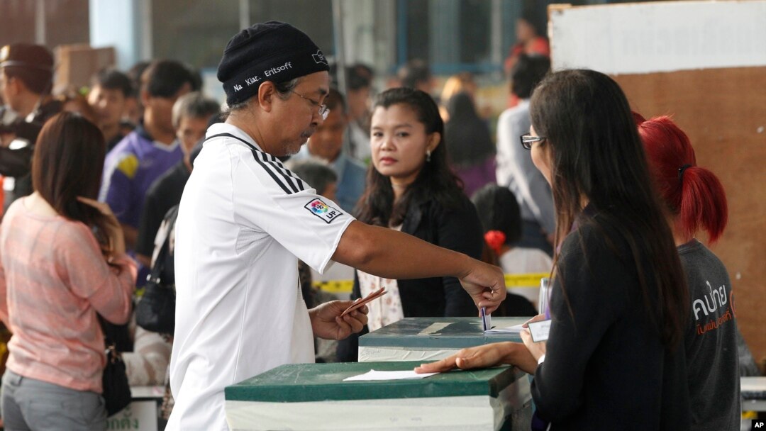 A local resident casts his ballot for the general election at a polling station in Bangkok, Thailand, Sunday, Feb. 2, 2014.