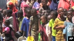 Twice a day, crowds of hungry people line up outside feeding centers all across Mogadishu, holding a pan or a bucket to receive a hot meal