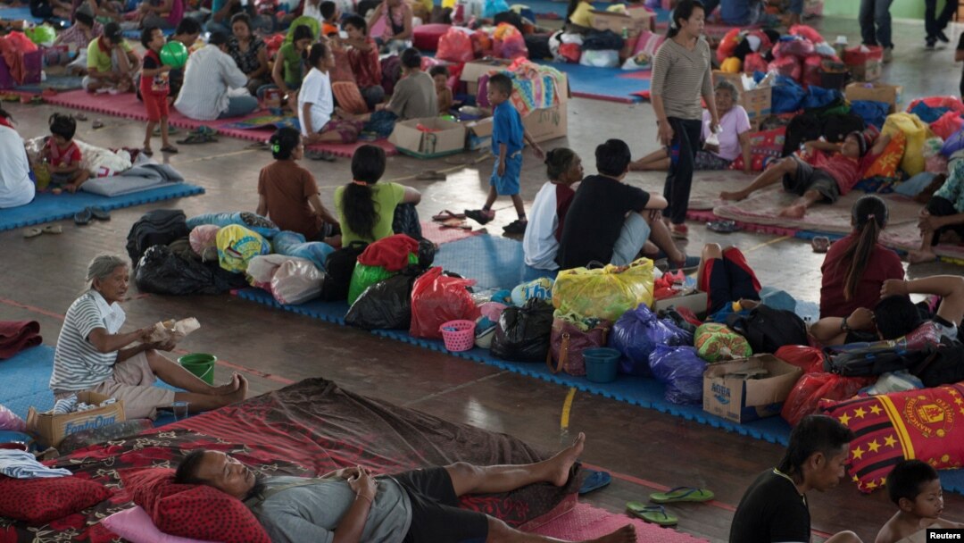 Villagers rest at a temporary evacuation center for people living near Mount Agung, a volcano on the highest alert level, inside a sports arena in Klungkung, on the resort island of Bali, Indonesia, Sept. 28, 2017, in this photo taken by Antara Foto.