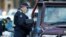 Police stop drivers at a checkpoint, set up in response to the state of Victoria's surge in coronavirus disease cases and resulting suburb lockdowns, in Melbourne, Australia, July 2, 2020. 