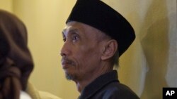 FILE - In this Feb. 22, 2012 file photo, Sujitno Sajuti of Indonesia attends a rally by Connecticut immigrants and social rights advocates against the federal Secure Communities program the State Capitol in Hartford, Connecticut.