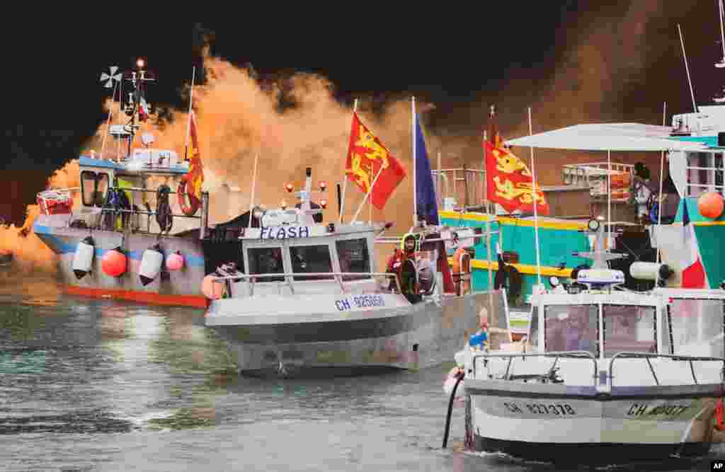 Fishing vessels are seen at sea off the coast of Jersey, Britain. French fishermen, angry over loss of access to waters off their coast, have gathered their boats in protest off the English Channel island of Jersey.