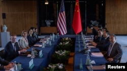 Chinese Foreign Minister Wang Yi, far right, and White House National Security Adviser Jake Sullivan, far left, pose for a photo before talks at Yanqi Lake in Beijing, China, on Aug. 27, 2024.