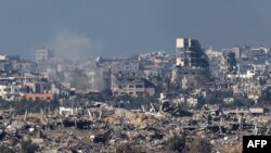 A picture taken in southern Israel near the border with the Gaza Strip on December 15, 2023, shows destruction in northern Gaza resulting from weeks of Israeli bombardment of the Palestinian territory amid ongoing battles with the Hamas militant group.