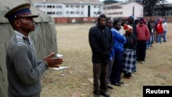 People wait to cast their votes in Mbare township outside Harare July 31, 2013.