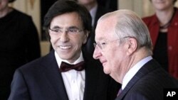 The chief of Belgium's francophone Socialist Party (PS) Elio Di Rupo (L) poses with King Albert II (R) after being sworn in as Prime Minister at the Laeken Royal Palace in Brussels December 6, 2011.