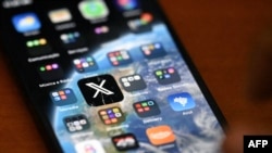 The app icon for social media platform X is seen on a smartphone in Rio de Janeiro, Brazil, Sept. 18, 2024. Brazilian X users reported being able to access the platform, suspended in Latin America's largest country by a decision of the Supreme Court.