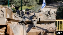 An Israeli army Merkava main battle tank is deployed by the concrete border wall at a position along Israel's northern border with Lebanon on Feb. 18, 2025.