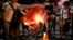 Students burn a Chinese flag as they protest against the visit of Chinese President Xi Jinping during a demonstration outside the Presidential Palace in Manila, Philippines, Nov. 20, 2018.
