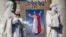 FILE - The tapestry with the image of Pope Paul VI is unveiled as Pope Francis celebrates the mass for his beatification in St. Peter's square at the Vatican, Oct. 19, 2014. 