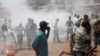 Opposition protesters disperse after tear gas is fired in their midst, in Conakry, Guinea, February 27, 2013. 