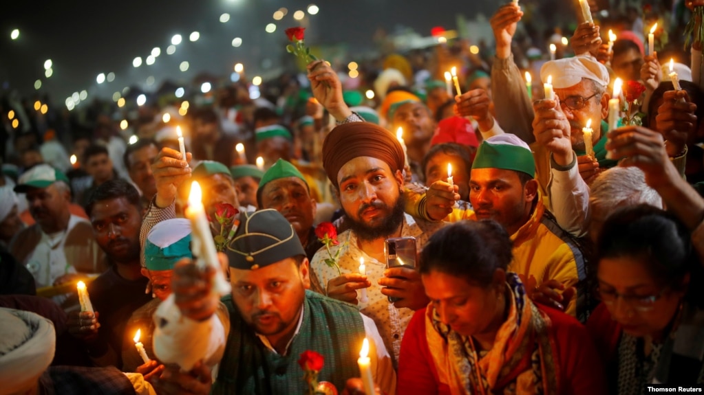 FILE - Farmers take part in a candlelight vigil to honor paramilitary troops killed in a suicide bomb attack in south Kashmir's Pulwama district in 2019, at the site of a protest against new farm laws in Ghaziabad, India, February 14, 2021. REUTERS/Adnan Abidi
