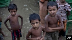 FILE - Rohingya children gather at the Dar Paing camp for Muslim refugees, north of Sittwe, western Rakhine state, Myanmar.