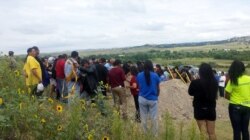 Mourners attend the burial of a 19 year-old Oglala Lakota suicide victim on South Dakota's Pine Ridge Reservation, August 17, 2015. Courtesy: Keith Janis.