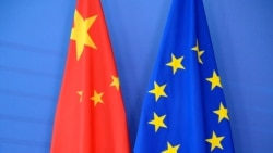FILE - A Chinese flag, left, is draped beside the European Union (EU) flag during a EU-China Summit at European Union Commission headquarters in Brussels, June 29, 2015.