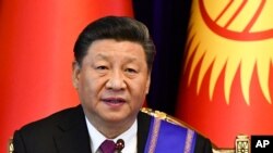 FILE - Chinese President Xi Jinping attends a joint news conference with Kyrgyzstan's President Sooronbai Jeenbekov, in Bishkek, Kyrgyzstan, June 13, 2019.