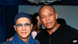 FILE - Music industry entrepreneur Jimmy Iovine, left, and hip-hop mogul Dr. Dre at a Grammy Party in Los Angeles, Feb. 10, 2013.