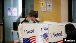 A man wears a face mask as he votes at an early voting site in Arlington, Virginia, U.S., September 18, 2020. 