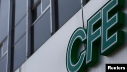 FILE - The logo of Mexico's state-run electricity utility known as the Federal Electricity Commission, or CFE by its Spanish acronym, is seen outside its Mexico City office.