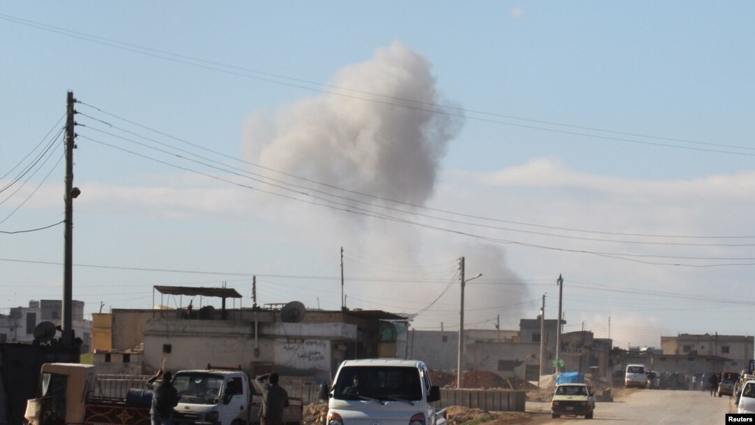 FILE - Smoke rises in a site hit by what activists said were airstrikes carried out by the Russian air force in the town of Saraqib, in Idlib province, Syria, Jan. 9, 2016.