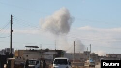 FILE - Smoke rises in a site hit by what activists said were airstrikes carried out by the Russian air force in the town of Saraqib, in Idlib province, Syria, Jan. 9, 2016.