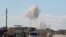 FILE - Smoke rises in a site hit by what activists said were airstrikes carried out by the Russian air force in the town of Saraqib, in Idlib province, Syria, Jan. 9, 2016.