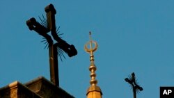 FILE - A minaret of the Mohammed al-Amin Mosque and two crosses on top of the Maronite St. George Cathedral are seen in downtown Beirut, Lebanon, Sept. 17, 2006. Muslims, by 2016, are expected to make up about 31 percent of world’s population, trailing Christians by just one percent.