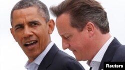 U.S. President Barack Obama walks with Britain's Prime Minister David Cameron during the G8 summit at the Lough Erne golf resort in Enniskillen, Northern Ireland, June 18, 2013.