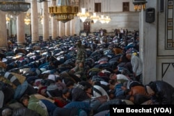 A Hayat Tahir al-Sham soldier stands guard inside the Umayyad Mosque during the Friday prayers in Damascus, Syria, Dec. 14, 2024.