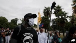 Members of "Brigade Anti Negrophobia" and anti-racism groups attend a "de-colonial tour" next to the French capital's Museum of Immigration, seen in background, July 5, 2020.