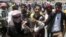 Anti-Houthi protesters carry an injured fellow protester during clashes with Houthi fighters in Yemen's southwestern city of Taiz, March 22, 2015. 