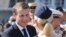 French President Emmanuel Macron shakes hands with French military personnel at the naval base during his second day of visit in Abu Dhabi, United Arab Emirates, Thursday, Nov. 9, 2017. 