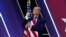 Дональд Трамп обнимает флаг США на конференции CPAC-2020.