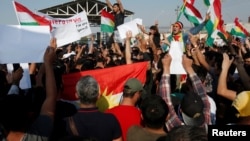 Syrian Kurds protest the Turkish offensive against Syria during a demonstration in front of the United Nation Headquarter in Erbil, Iraq Oct. 10, 2019. 