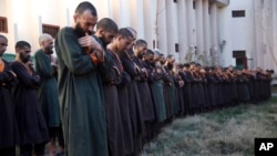 FILE- in this Dec. 21, 2019, photo, Islamic State militants who had either been arrested or had surrendered to the Afghan government are presented to media in Kabul, Afghanistan.