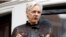 FILE - WikiLeaks founder Julian Assange gestures to supporters outside the Ecuadorian Embassy in London, where he has been in self-imposed exile since 2012, May 19, 2017.
