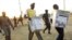 Election officials carry ballot boxes moments after polls closed in Juba, Southern Sudan, on January 15, 2011. South Sudan is due to hold a general election in July 2015.