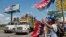 FILE - Supporters of Nicaragua's President Daniel Ortega wave flags of the Sandinista National Liberation Front as farmers opposed to the construction of Nicaragua's interoceanic canal join a national protest against the project, in Managua, Nicaragua, Oct. 27, 2015.