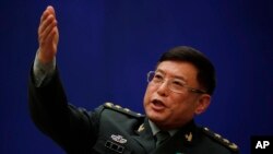 Vice president of China's Academy of Military Sciences, Lt. Gen. He Lei gestures as he speaks during a press conference on the sidelines of the National People's Congress at the State Council Information Office in Beijing, March 8, 2018. 